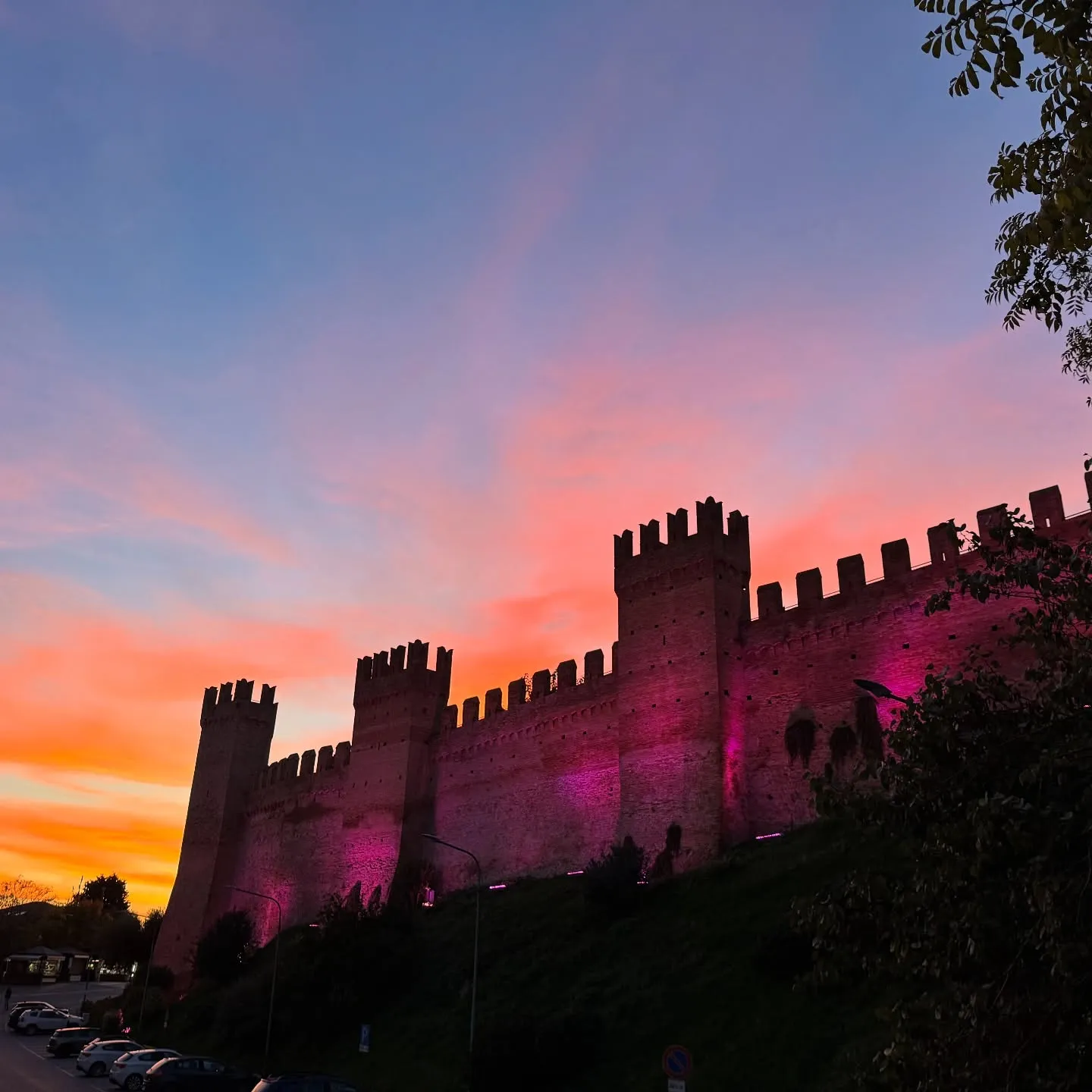 Gradara — mura merlate accese dalla luce del tramonto.
