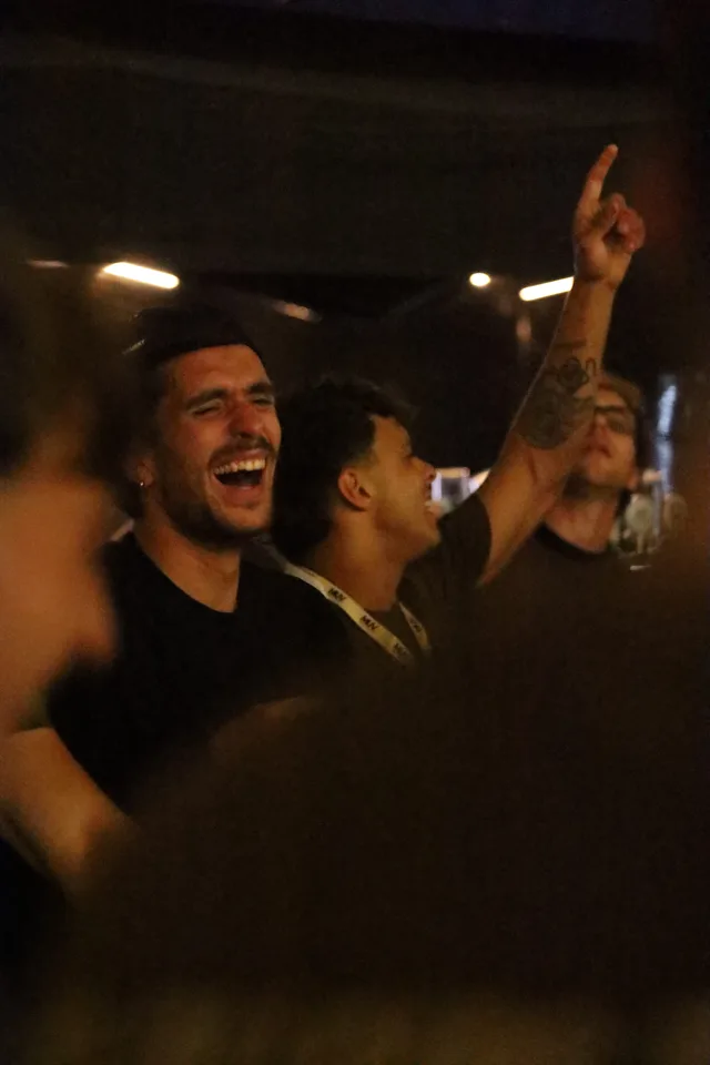 Un partecipante canta con il braccio alzato nel finale della festa.